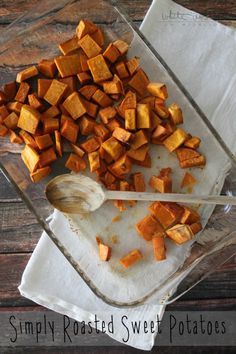 sweet potatoes in a glass dish with a wooden spoon on a white towel next to them