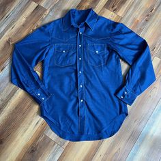 "Like new condition 70's style snap shirt. Has a satin print that kind of gives off disco vibes. No sizing or brand but fits like a small/medium. Please refer to measurements for best fit.  21\" pit to pit  31\" long 36.5\" nape to sleeve cuff B02" Western Style Blue Tops With Buttons, Retro Long Sleeve Top With Pockets, Fitted Shirt With Retro Print For Fall, Fitted Blue Tops With Snap Buttons, Western Long Sleeve Tops With Snap Buttons, Fitted Long Sleeve Shirt With Retro Print, Long Sleeve Shirt With Retro Print, Retro Long Sleeve Blue Shirt, Retro Long Sleeve Tops With Snap Buttons