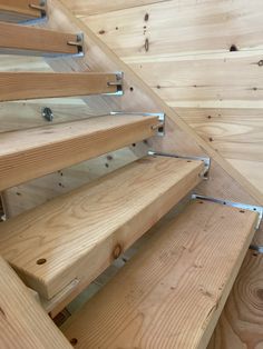 wooden stairs with metal handrails and wood flooring