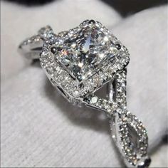 an engagement ring is shown on top of a white cloth with the diamond set in it