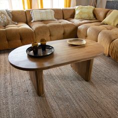 a living room with couches and a coffee table in the middle of the room