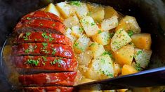 a crock pot filled with meat and potatoes