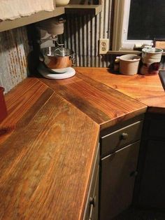 a wooden counter top in a kitchen next to a window