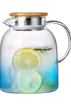 a glass pitcher filled with water and lemon slices