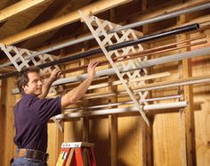 a man is working on some kind of rack in a building with wood paneling