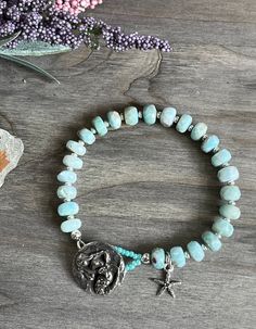 This lovely Larimar bracelet reminds me of the beach. The soothing color of the Larimar is put together with small stainless steel beads in between. The closure is a pretty GGS mermaid button. I also added a small starfish to complete the look. 7 1/4"  #beadedartbyv #beadedearrings #beadedjewelry #HandCraftedJewelry #artisanjewelry #artisanmade #larimarjewelry #larimarbracelet Adjustable Turquoise Larimar Beaded Bracelets, Larimar Bracelet, Mermaid Bracelet, Larimar Jewelry, Soothing Colors, Artisan Jewelry, Handcrafted Jewelry, Beaded Earrings, Mermaid