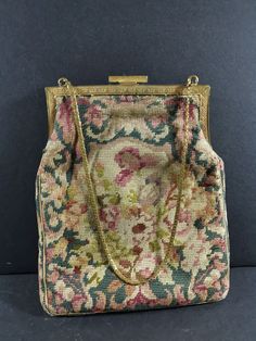 Step back in time with this exquisite Antique Petit Point Hand Bag Wrist Purse, a true gem from the early 1900s boasting intricate petite point embroidery and a luxurious gold metal frame. Meticulously crafted with skill and precision, this purse exudes vintage elegance and timeless charm. The delicate embroidery showcases stunning attention to detail, with intricate patterns and motifs that captivate the eye. The gold metal frame adds a touch of opulence, elevating this piece to a coveted acces Victorian Style Gold Embroidered Bag, Vintage Embroidered Ceremonial Bags, Vintage Embroidered Formal Bags, Victorian Style Embroidered Rectangular Bag, Wrist Purse, Delicate Embroidery, Chain Top, Vintage Elegance, Early 1900s