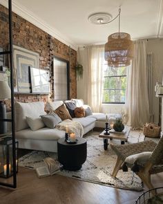 a living room filled with furniture and a fire place in front of a brick wall