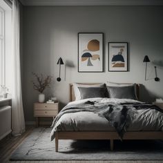 a bed sitting in a bedroom next to two framed pictures on the wall above it