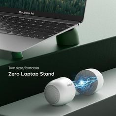 two wireless devices sitting on top of a table next to a laptop