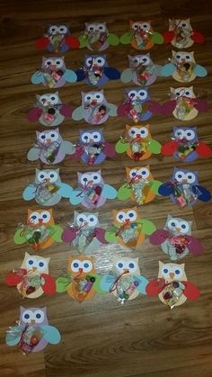 an assortment of paper owls sitting on top of a wooden floor