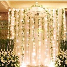 the wedding stage is decorated with white flowers and greenery