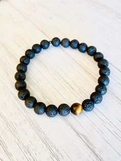 Only for the sexy men. 8mm Black from the earth Lava Stones beads with 1 Tigers Eye bead on a strong black stretch cord. Mens bracelets should generally fit a bit more snug so it doesn't hang. Order size accordingly. Adjustable Black Stretch Bracelet For Meditation, Casual Stretch Bracelet With 8mm Lava Stone Beads, Black Lava Stone Beaded Bracelets, Hand-strung, Hand-strung Black Lava Stone Beaded Bracelets, Black Hand-strung Lava Stone Beaded Bracelets, Black Lava Stone Stretch Bracelet As Gift, Black Hand-strung Stretch Bracelet For Meditation, Adjustable Lava Stone Bracelet For Meditation, Adjustable Lava Stone Stretch Bracelet For Meditation