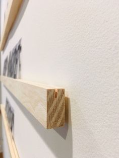 two pieces of wood are hanging on the wall