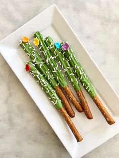 asparagus with sprinkles and flowers on a white platter, ready to be eaten