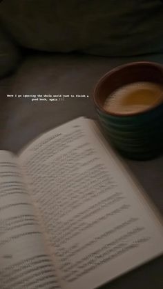 an open book next to a cup of coffee