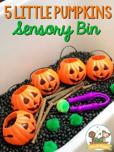 five little pumpkins in a white container with scissors and black beans on the ground