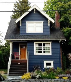 a blue house with white trim and windows