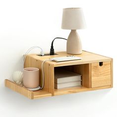 a wooden shelf with a lamp and some books on it