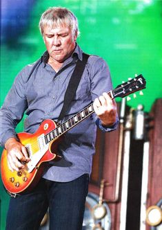 a man playing an electric guitar on stage