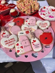 a table topped with lots of heart shaped cookies