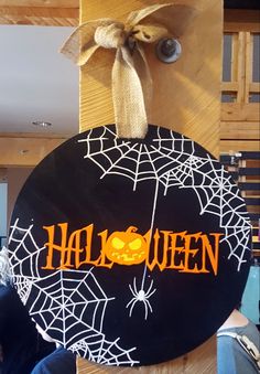 a wooden sign that says halloween on it