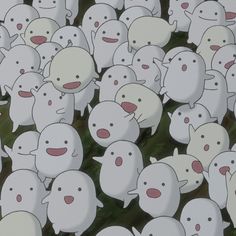 a large group of white sheep standing next to each other on top of a field