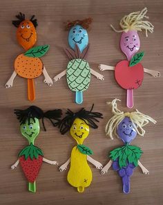 the children's handmade fruits and vegetables are arranged in rows on a table