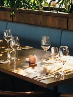 a table with wine glasses and an onion on it