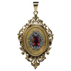 France, circa 1880s This ornate 18K gold locket pendant is designed in the Renaissance Revival style. The front is centered with a reddish orange citrine (10 x 6.7 x 4.4 mm) framed by a silver wreath embellished with rose cut diamonds. The interior is fitted with two miniature picture frames. Marked on the back cover and bezel with eagle’s head French assay mark for 750 gold standard (18K). Total length with bail is 62 mm (2 3/8 in.) Width is 34 mm (1 1/4 in.) Weight is 14.83 grams. Sold without 1600s Jewelry, 1880s Jewelry, Miniature Picture Frames, Silver Wreath, Orange Citrine, Victorian Locket, Antique Locket, Reddish Orange, Gold Locket