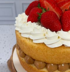 a close up of a cake with strawberries on top