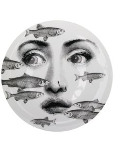 a plate with fish on it and a woman's face