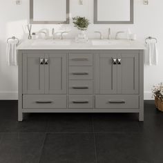 a bathroom with two sinks and mirrors on the wall