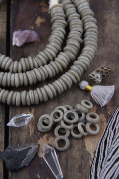 "Grey Dutch Donut Dogon Beads, Mali, Africa, Large Hole Glass Beads, Neutral Fall Boho Bohemian Tribal 11-12mm, Jewelry Making Supply, 10 pcs These are really enchanting and delicate beads hailing from the dogon Tribe in Mali. Called \"Dutch Donuts\" because of their donut-like shape, and because they formed in a style of Dutch beads that were traded into Africa. They are made of glass that was wrapped around a mandrel and formed into this round shape. These beads are wound glass, so on some bea Dogon Tribe, Mali Africa, African Trade Beads, Boho Fall, Bone Beads, Shopping World, African Beads, Trade Beads, Beignets