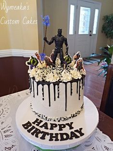 a birthday cake with an alien figure on top