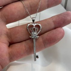 "Love Heart Crown Key 925 Sterling Silver Pendant Necklace Created Diamond Chain Size: 18\" (45.7 cm), including the clasp  Pendant Size: 4.8 cm X 1.5 cm  Main Stone Size: 7 mm X 7 mm (1.25 Carat)  Main Stone Shape: Round Cut  Metal: Real Solid 925 Sterling Silver  Hallmark: 925 Plating: Rhodium Plated  Stones: High-Quality Created Diamond  Finish: High Polished Nickel Free Lead-Free ATTENTION: Our Created Diamond is created to be optically identical to a Natural Diamond. However, they are not m Silver Gemstone Heart Necklace For Anniversary, Silver Heart Necklace With Gemstone, Silver Elegant Heart Necklace With Gemstone, Silver Heart Necklace With Clavicle Chain For Mom, Elegant Silver Heart Necklace With Gemstone, Sterling Silver Heart Pendant Jewelry Gift, Sterling Silver Heart Necklace With Gemstone, Stamped 925 Cubic Zirconia Necklace For Anniversary, Cubic Zirconia Necklace Stamped 925 For Anniversary