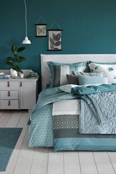 a bedroom with blue walls and white floors