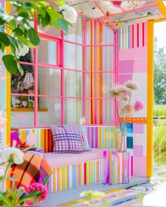 the colorful room is decorated with flowers and plants in vases on the windowsill