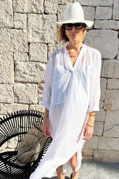 This modern khadi stripe caftan is slightly sheer and incredibly soft and luxurious feeling.. This piece drapes beautifully and can be worn with a slip for day wear or as a cover up all summer long. So soft you won't want to take it off! WHY WE LOVE IT Made in New York using textiles and saris from India, Two is a modern and minimalist take on caftans, tunics, and easy dresses. Two has been committed to reinforcing the importance of handmade fabrics by supporting weavers and talented artisans and designers. Handweaving fabrics save 1 ton of co2 emissions per year per handloom. Fabrics are the essential first step when designing a piece. DETAILS - Semi-sheer handwoven khadi fabric, 100% cotton SIZE Width (flat) 34.5" / Length 49" One Size, chic boxy fit. ABOUT TWO NEW YORK Chic Tunic Kaftan For Daywear, Chic Kaftan Tunic For Daywear, Chic Daywear Kaftan, Chic White Tunic Kaftan, Chic Relaxed Fit Kaftan For Beach Cover-up, Elegant Beach Tunic With Relaxed Fit, Elegant Relaxed Fit Beach Tunic, Elegant Relaxed Fit Tunic For Beach, Chic White Kaftan For Beach Cover-up