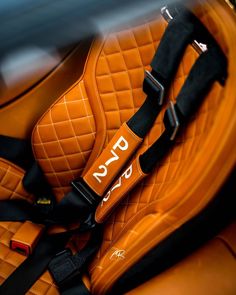 an orange car seat with the word dyca on it's back end