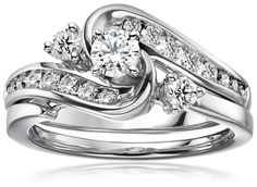 a white gold ring set with diamonds on the side and an engagement band in the middle