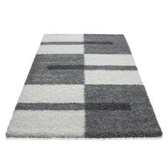 a rug with different colors and shapes on the floor in front of a white background