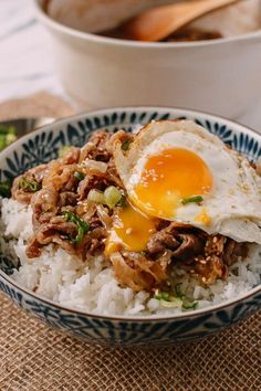 an egg is on top of rice in a bowl