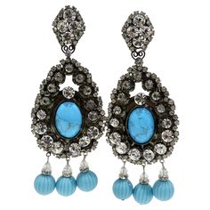 These huge Lawrence VRBA earrings are a rare find. Look no further for a one-of-a-kind statement earring to wear to your next event. Dozens of clear crystals surround a large turquoise stone and drop details add a sense of elegance. Don't blend in and pair these with your Saint Laurent cocktail dress and some Louis Vuitton heels. Length: 5in Width: 2in Louis Vuitton Heels, Turquoise Chandelier, Statement Earring, Clear Crystals, Turquoise Earrings, Chandelier Earrings, Turquoise Stone, Clear Crystal, Clip On Earrings