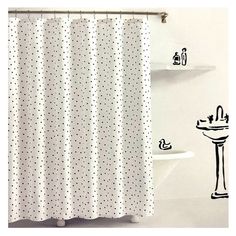 a white shower curtain with black polka dots on it and a sink in the background