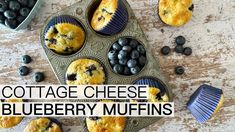 blueberry muffins with cottage cheese in the middle on a wooden table surrounded by fresh blueberries