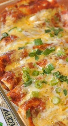 a cheesy casserole with green peppers and onions in a pan on a table