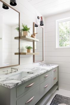 a bathroom with two sinks and a large mirror above the sink is featured in this article