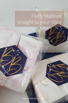 three white soaps wrapped in cellophane with gold foil on them and the words fluffy mallows straight to your door