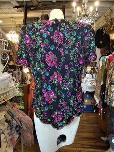 "This is a vintage beaded and sequinned silk top from the 1980's or 1990's. The label is from Stenay, marked size large. It features a vivid floral pattern in pink, teal, green and gold beads and sequins. This top open down the back with a well working zipper. This top is in excellent condition. Lined, with removable shoulder pads. Comes from a smoke free home. Measurements: Bust: 40\" Waist: 34\" Hip: 42\" Across Shoulder: 16.5\" Sleeve Length: 9\" Length from Shoulder: 27\" Please ask me any q Vintage Embroidered Party Tops, Vintage Embroidered Tops For Parties, Vintage Embroidered Party Blouse, Vintage Embroidered Blouse For Party, Embellished Multicolor Party Blouse, Embellished Multicolor Blouse For Party, Multicolor Embellished Blouse For Party, Multicolor Silk Tops For Evening, Vintage Beaded Tops For Party